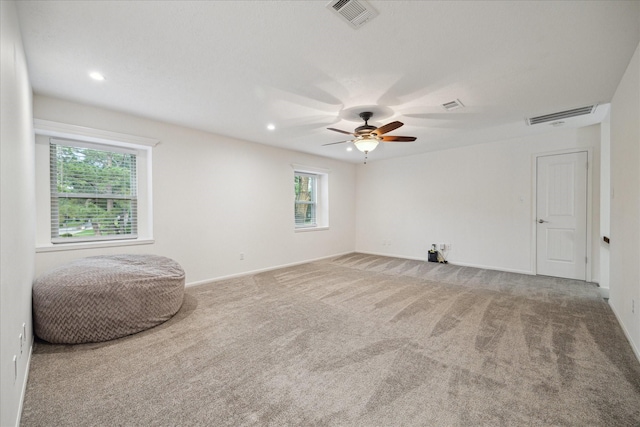 unfurnished room with visible vents, carpet, and a wealth of natural light