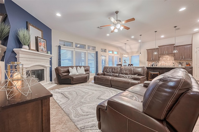 living room with recessed lighting, a glass covered fireplace, and ceiling fan