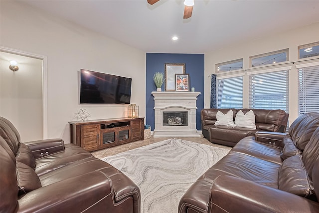 tiled living room with recessed lighting, a ceiling fan, baseboards, and a glass covered fireplace