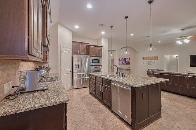 kitchen with ceiling fan, dark brown cabinetry, appliances with stainless steel finishes, a sink, and visible vents