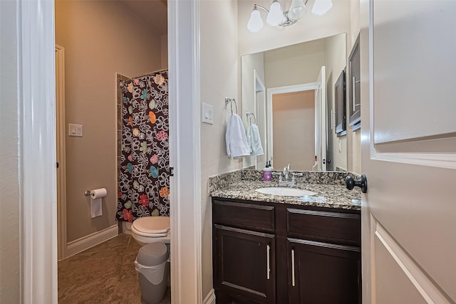 bathroom featuring toilet, baseboards, tile patterned flooring, and vanity