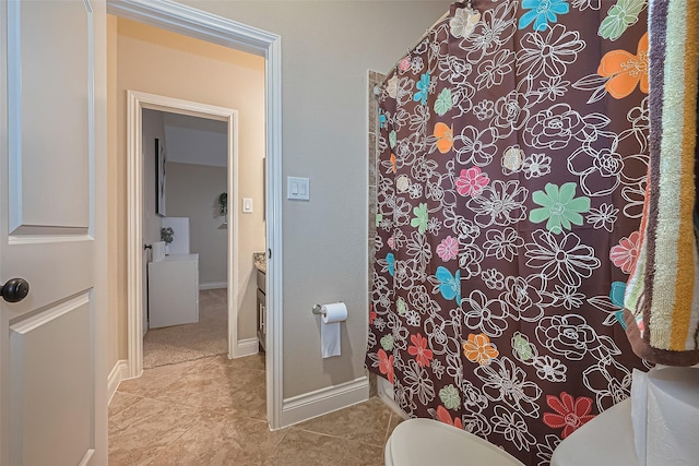 bathroom with tile patterned flooring, baseboards, toilet, and a shower with curtain
