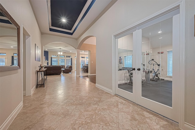 11918 Forest Moon Dr, Cypress, TX 77433 - hall featuring french doors, arched walkways, healthy amount of natural light, and baseboards