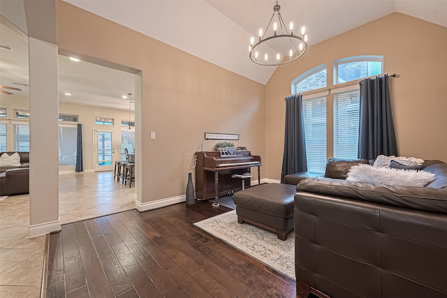 living room featuring baseboards, vaulted ceiling, dark wood finished floors, and a wealth of natural light