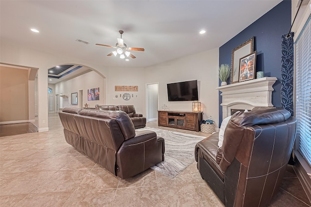 11918 Forest Moon Dr, Cypress, TX 77433 - living area with ceiling fan, arched walkways, a fireplace, recessed lighting, and light tile patterned flooring