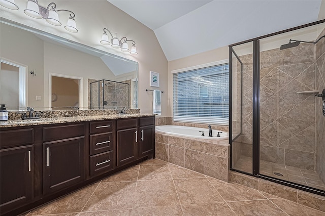 full bathroom featuring a sink, double vanity, lofted ceiling, a garden tub, and a stall shower