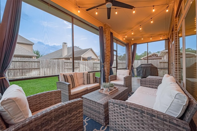 sunroom with an outdoor living space, a ceiling fan, and track lighting