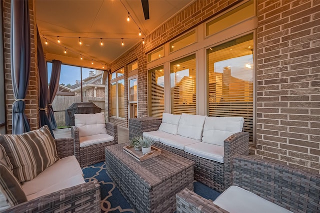 sunroom with an outdoor living space and rail lighting