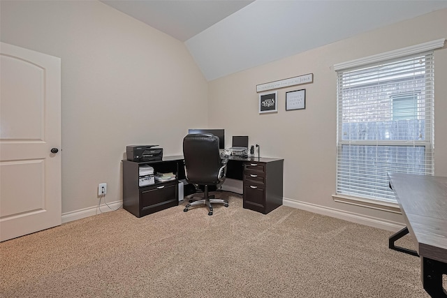 office area with baseboards, light colored carpet, and lofted ceiling