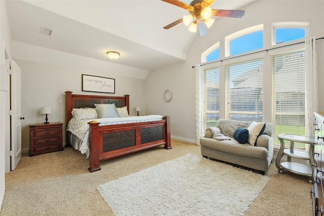 bedroom featuring a ceiling fan, light colored carpet, lofted ceiling, and visible vents