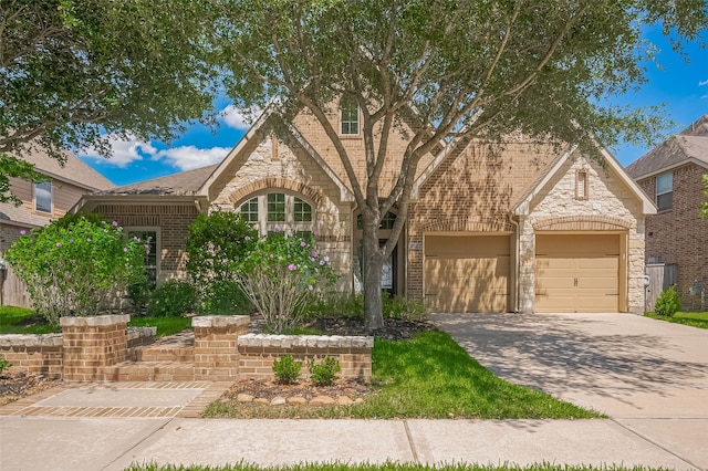 11918 Forest Moon Dr, Cypress, TX 77433 - view of front of house featuring stone siding, brick siding, driveway, and an attached garage