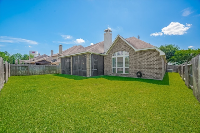 11918 Forest Moon Dr, Cypress, TX 77433 - back of property featuring a sunroom, brick siding, a shingled roof, and a chimney