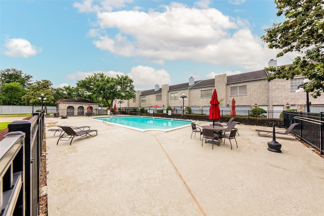 pool featuring a patio and fence