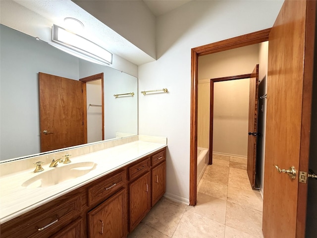 7110 W Mockingbird Ln, Pearland, TX 77584 - full bath with vanity, a tub to relax in, tile patterned floors, and baseboards