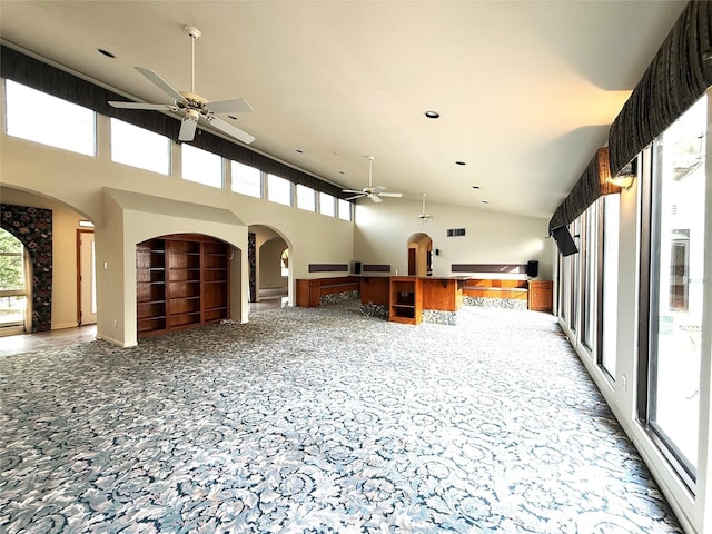7110 W Mockingbird Ln, Pearland, TX 77584 - unfurnished living room with ceiling fan, high vaulted ceiling, carpet, arched walkways, and built in features
