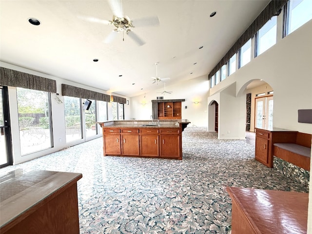 7110 W Mockingbird Ln, Pearland, TX 77584 - kitchen with ceiling fan, arched walkways, open floor plan, healthy amount of natural light, and recessed lighting