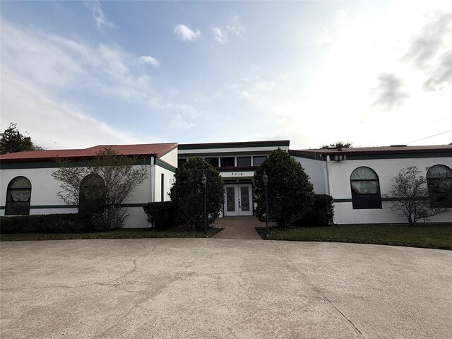 7110 W Mockingbird Ln, Pearland, TX 77584 - view of front facade featuring french doors and stucco siding