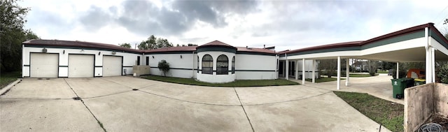 7110 W Mockingbird Ln, Pearland, TX 77584 - view of front of home featuring an attached garage, concrete driveway, and stucco siding