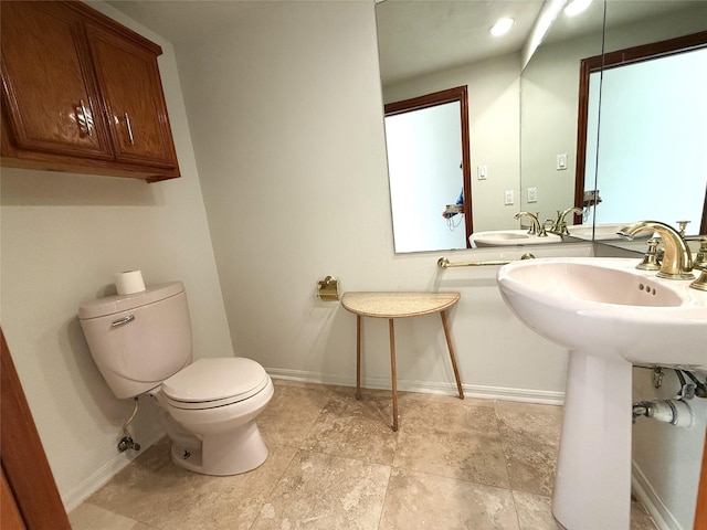 7110 W Mockingbird Ln, Pearland, TX 77584 - bathroom featuring toilet and baseboards