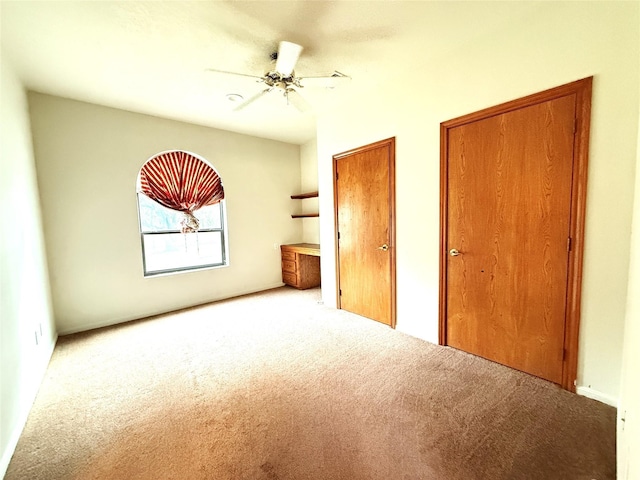 7110 W Mockingbird Ln, Pearland, TX 77584 - unfurnished bedroom featuring carpet floors, two closets, and ceiling fan
