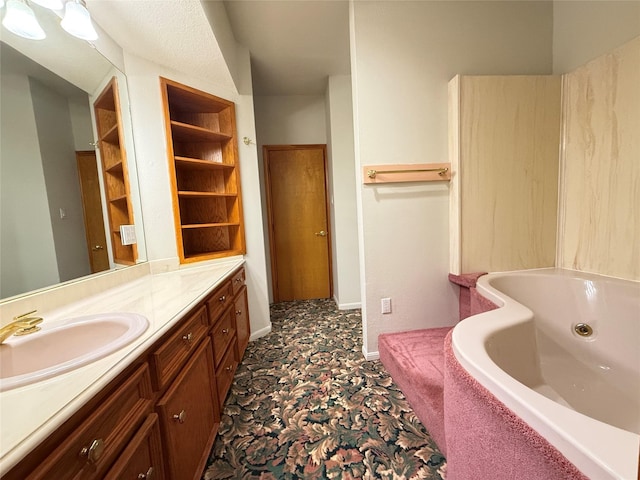 7110 W Mockingbird Ln, Pearland, TX 77584 - bathroom with vanity and a tub with jets