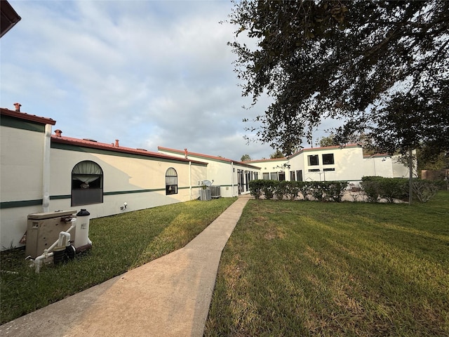 7110 W Mockingbird Ln, Pearland, TX 77584 - view of green lawn with cooling unit