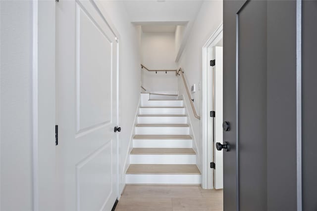staircase with wood finished floors