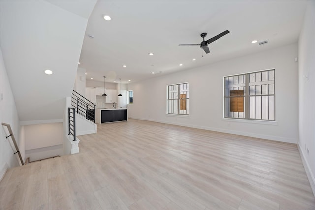 unfurnished living room featuring recessed lighting, a ceiling fan, light wood-style flooring, and visible vents