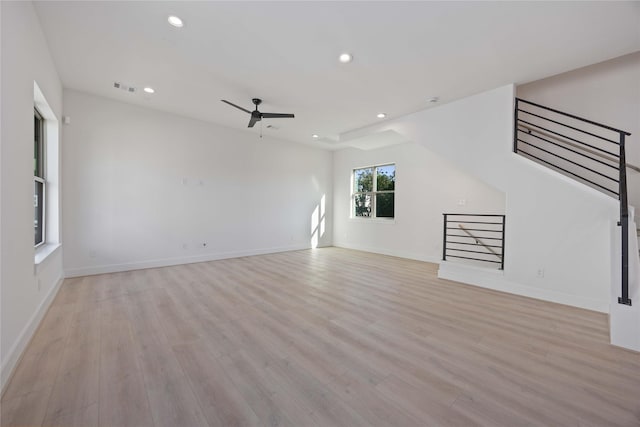 unfurnished living room with a ceiling fan, visible vents, baseboards, recessed lighting, and light wood-style flooring