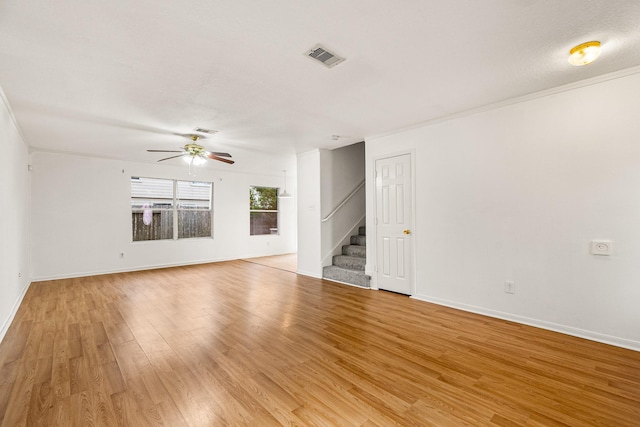 19627 Lighthouse Scene Ln, Cypress, TX 77433 - spare room featuring light wood-type flooring, stairs, ceiling fan, and visible vents