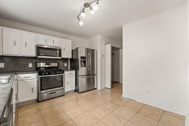 19627 Lighthouse Scene Ln, Cypress, TX 77433 - kitchen with white cabinets, appliances with stainless steel finishes, light tile patterned floors, and tasteful backsplash