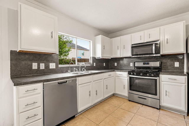 19627 Lighthouse Scene Ln, Cypress, TX 77433 - kitchen featuring a sink, dark countertops, stainless steel appliances, and white cabinetry