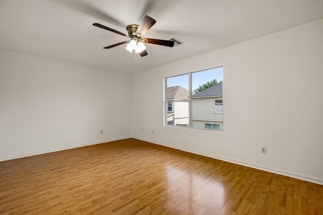 19627 Lighthouse Scene Ln, Cypress, TX 77433 - spare room featuring light wood-style floors, baseboards, a ceiling fan, and visible vents