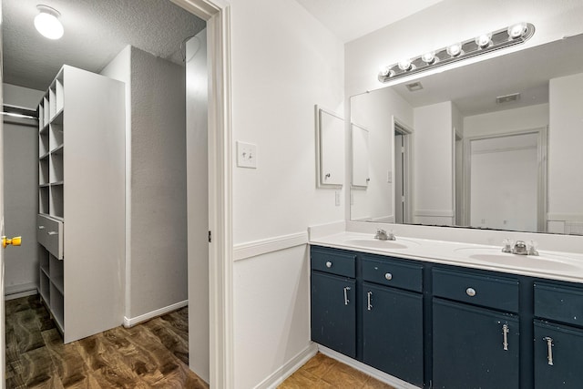 19627 Lighthouse Scene Ln, Cypress, TX 77433 - full bath featuring double vanity, a sink, wood finished floors, and visible vents