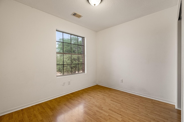 19627 Lighthouse Scene Ln, Cypress, TX 77433 - unfurnished room featuring baseboards, visible vents, and light wood-style flooring
