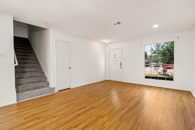 19627 Lighthouse Scene Ln, Cypress, TX 77433 - unfurnished living room with visible vents, light wood-style floors, baseboards, and stairway