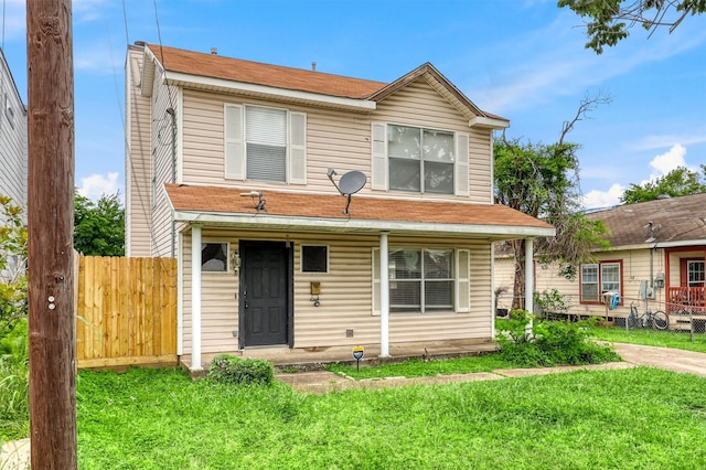 view of front of house featuring fence, a porch, and a front yard