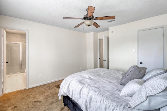 carpeted bedroom with baseboards, a ceiling fan, ensuite bath, and visible vents