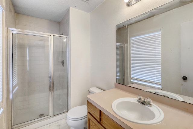 full bath with vanity, a shower stall, and toilet
