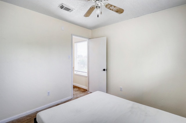 bedroom with visible vents, a ceiling fan, carpet, and baseboards