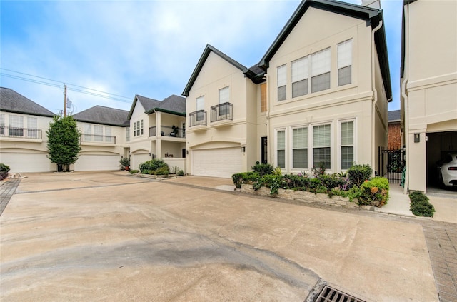view of front of home featuring a garage, stucco siding, and driveway