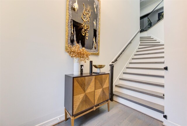 stairs featuring wood finished floors