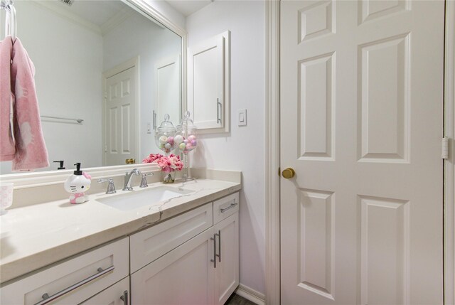 bathroom with vanity and ornamental molding