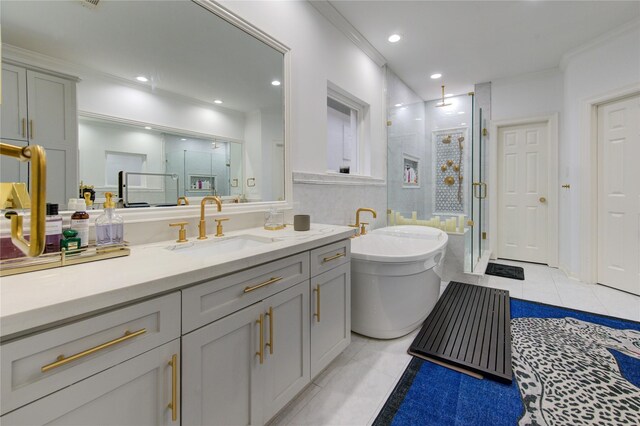 bathroom featuring a freestanding bath, a shower stall, tile patterned flooring, and vanity