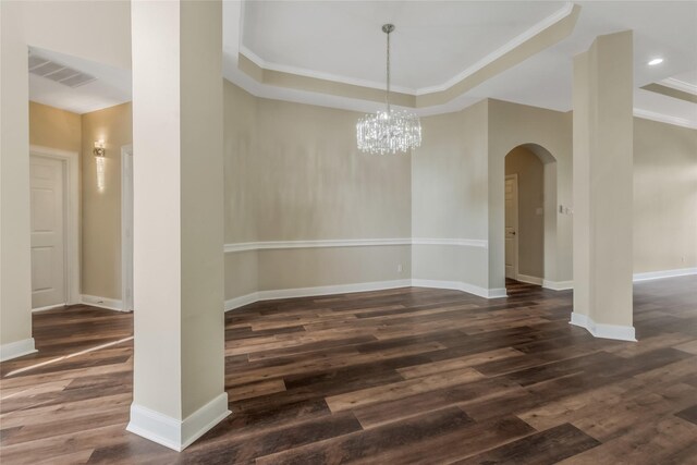 3515 Emerald Falls Ct, Houston, TX 77059 - unfurnished dining area featuring arched walkways, dark wood-style flooring, a chandelier, baseboards, and a tray ceiling
