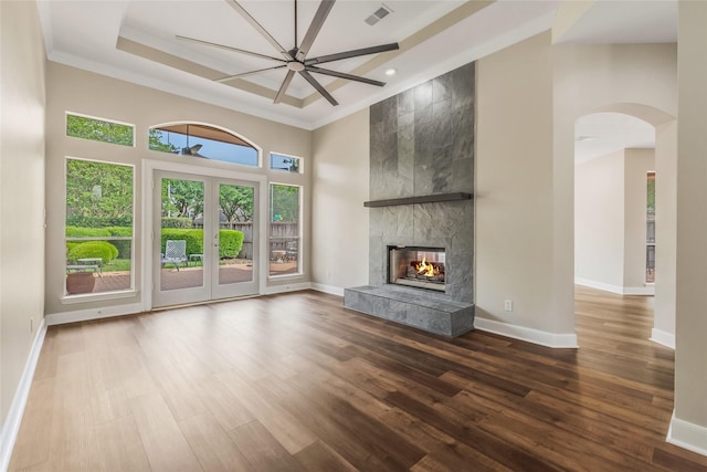 3515 Emerald Falls Ct, Houston, TX 77059 - unfurnished living room with ornamental molding, wood finished floors, arched walkways, a towering ceiling, and baseboards