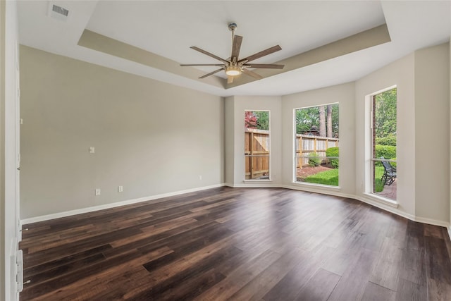 3515 Emerald Falls Ct, Houston, TX 77059 - empty room with a raised ceiling, a ceiling fan, dark wood-type flooring, and baseboards