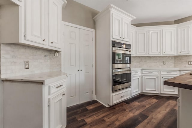 3515 Emerald Falls Ct, Houston, TX 77059 - kitchen featuring double oven, dark wood-type flooring, decorative backsplash, and white cabinetry