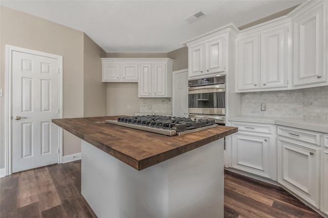 3515 Emerald Falls Ct, Houston, TX 77059 - kitchen with wooden counters, stainless steel appliances, tasteful backsplash, and white cabinetry