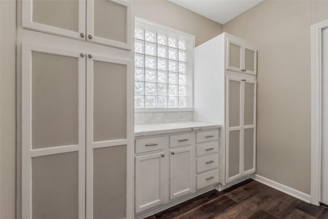 3515 Emerald Falls Ct, Houston, TX 77059 - kitchen featuring dark wood-style floors, white cabinets, baseboards, glass insert cabinets, and light stone countertops